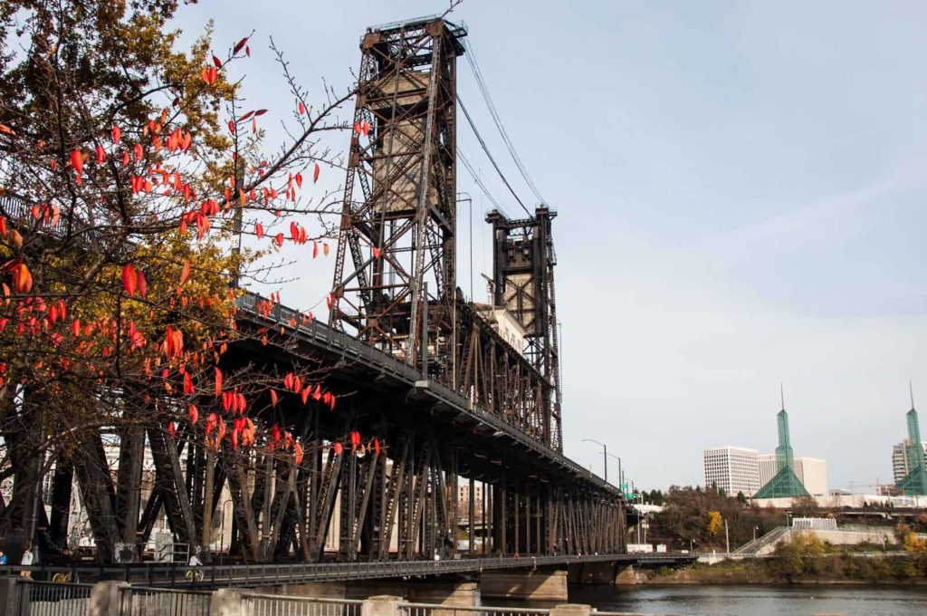 Portland steel bridge behind red leaves.